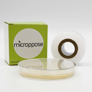 A box of clear poyfilm next to a roll of polyfilm with a petri dish covered in polyfilm in front.